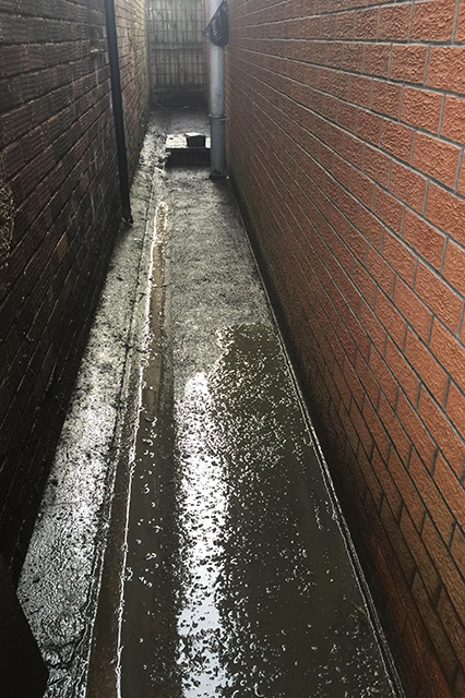Before Image showing dirty and wet alleyway